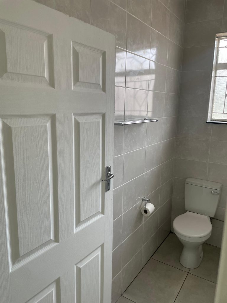 New wall and floor tiles around the bathroom doorway.